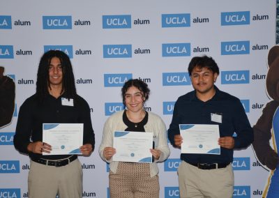 3 scholarship winners pose together, one girl in the middle, two boys on either side