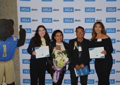 2 scholarship winners pose with the family of scholarship founders