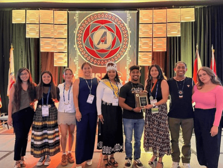 Justin Rodriguez, UCLA AISES Chapter President, and Desirae Barragan, UCLA AISES Chapter External Vice President (4th & 3rd  from rt. holding award) with UCLA AISES chapter members at the 2022 AISES National Conference in Palm Springs, CA